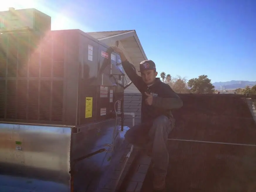 HVAC technician performing HVAC Inspection on a rooftop unit in Social Circle